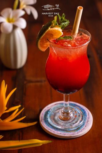 a red drink on a plate on a wooden table at Harvest Day Hoi An in Hoi An