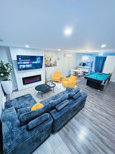 a living room with a couch and a pool table at Private Home Near Moncton Hospital&Downtown in Moncton