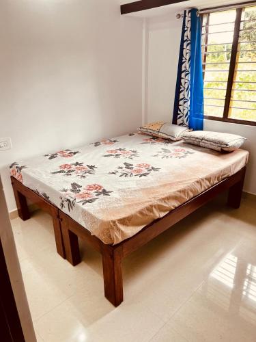 a large bed in a room with a table at Kannada Maathe Home Stay- 2km to Golden Temple-Tibet camp in Kushālnagar