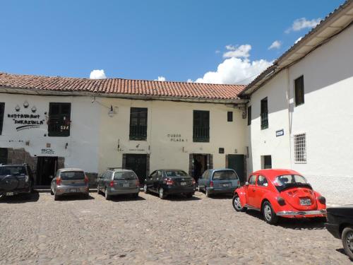 a group of cars parked in a parking lot in front of a building at Cusco Plaza Nazarenas in Cusco