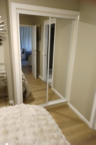 a mirror in a room with a bedroom and a living room at Island Rose - Luxe Resort Villa 3 x bedroom - Phillip Island in Cowes