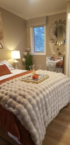 a large bed with a tray of food on it at Island Rose - Luxe Resort Villa 3 x bedroom - Phillip Island in Cowes