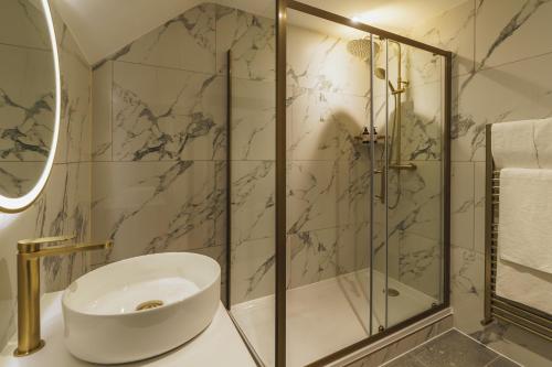 a bathroom with a sink and a shower at The Old Quay House Hotel in Fowey