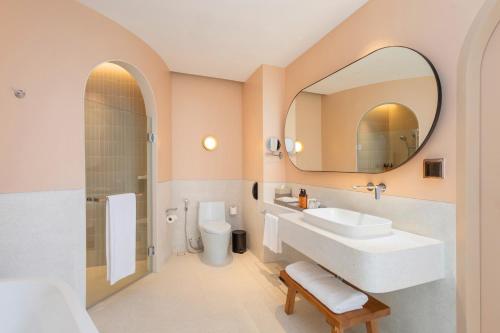 a bathroom with a sink and a mirror at Centara Karon Villas Phuket in Karon Beach