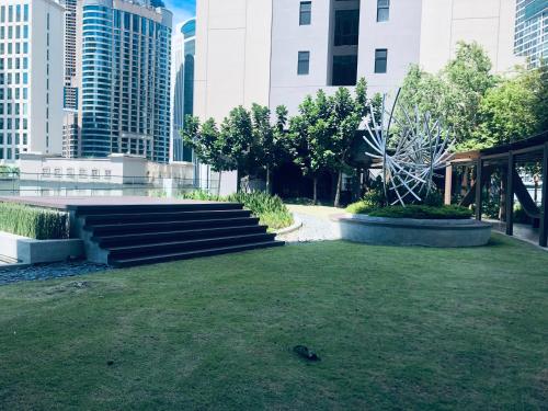a park with stairs in a city with tall buildings at Axon Residence Pavilion Bukit Bintang SkyView in Kuala Lumpur