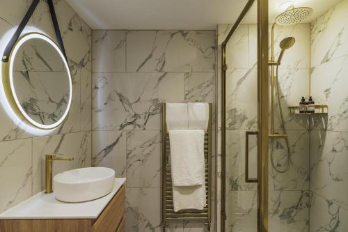 a bathroom with a sink and a shower at The Old Quay House Hotel in Fowey