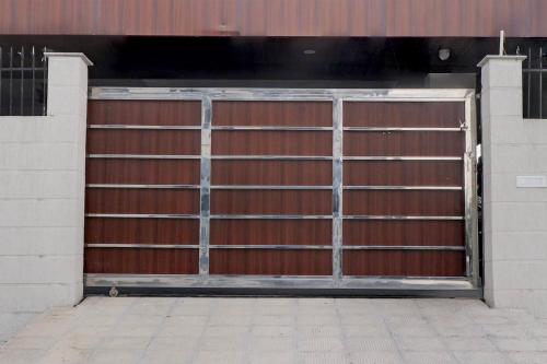 a pair of metal garage doors in a building at Super Townhouse Rispana River Dehradun Formerly Nivasa Home Stays in Dehradun