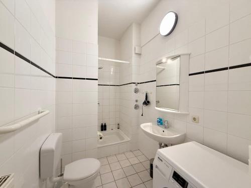 a white bathroom with a toilet and a sink at Berta - Zentrale Wohnung - 2 Küchenzeilen - Nähe Bahnhof in Schwerin