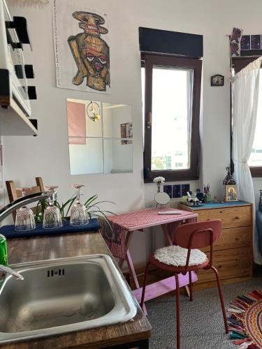 a kitchen with a sink and a table at Central Artsy Studio, self check-in! in Bucharest