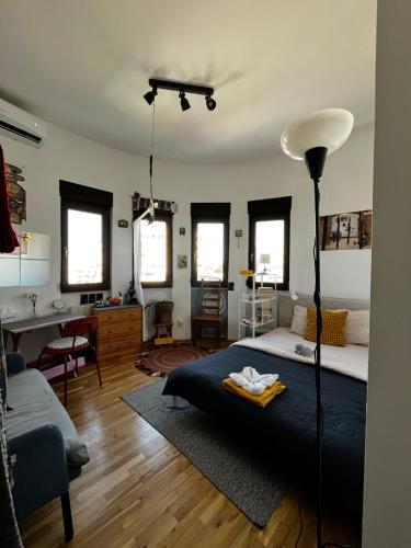 a bedroom with a bed and a living room at Central Artsy Studio, self check-in! in Bucharest