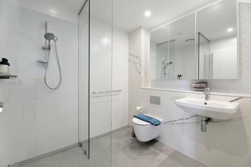 a bathroom with a toilet and a sink and a shower at Bright & Stylish 2-Bedroom Escape in Gordon in Gordon