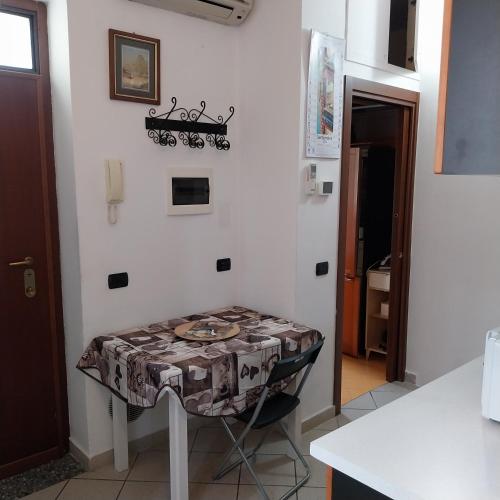 a table with a table cloth on it in a kitchen at B&B linate in Peschiera Borromeo