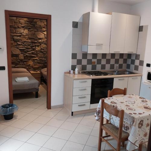 a kitchen with a table and a stove top oven at B&B linate in Peschiera Borromeo