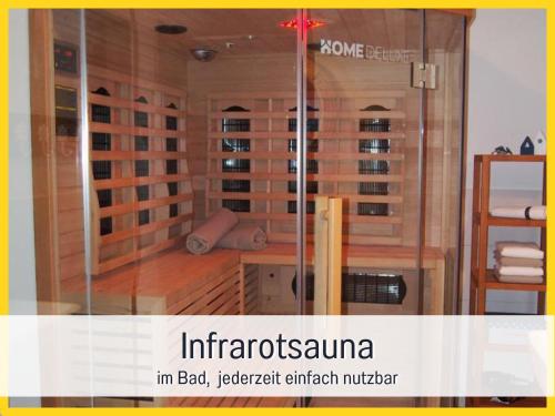 a room with a sauna with a glass wall at RamosHansenHof Fewo Fördebrise mit Sauna in Steinberg
