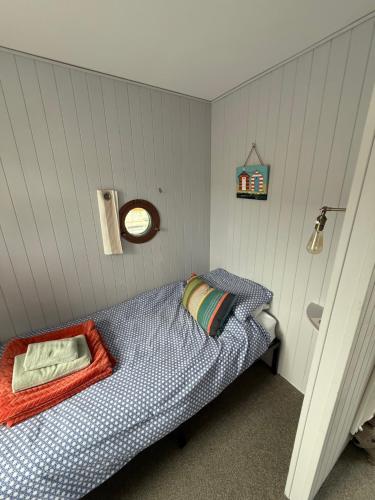 a bedroom with a bed with a clock on the wall at Clouds B&B in Kilmuir