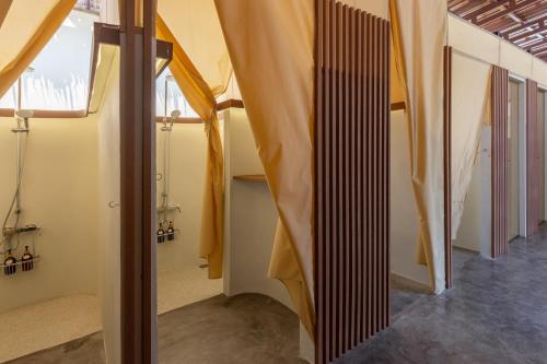 a room with a staircase with curtains in it at Camp Cayla - COASTA in Ban Ao Makham Pom