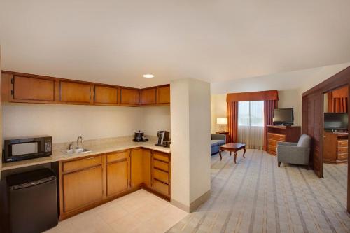 a kitchen and living room in a hotel room at Holiday Inn Express Dallas Market Center by IHG in Dallas