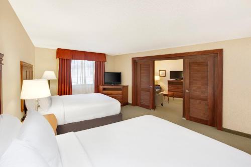 a hotel room with two beds and a television at Holiday Inn Express Dallas Market Center by IHG in Dallas