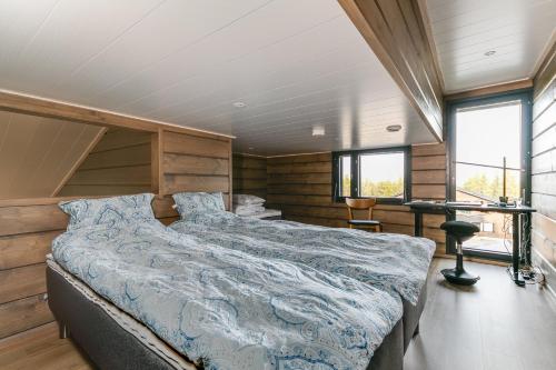a bedroom with a large bed in a house at Kinos A Visit Levi in Levi