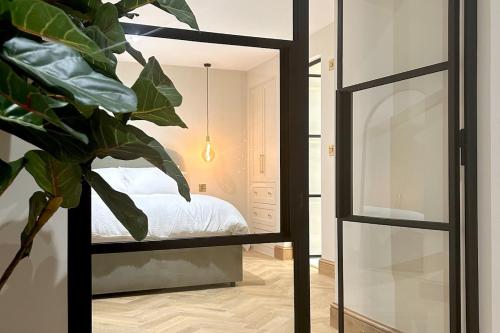 a mirror in front of a bedroom with a bed at Luxury Flat in Shaftesbury by JOT STAYS in Shaftesbury