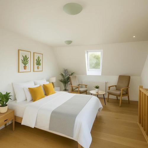 a bedroom with a large white bed with yellow pillows at Aarhus Stay Apartments in Hasselager