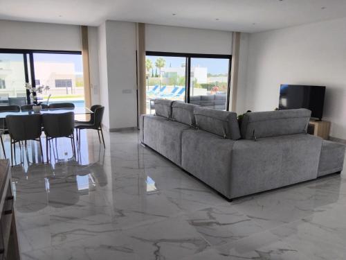 a living room with a couch and a table at Villa Paraiso in Alcantarilha