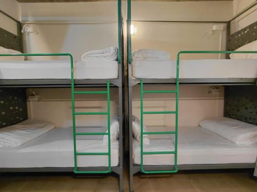 a bunk room with two bunk beds in it at Zostay Urban Retreat Deluxe Rooms & Premium Dorms in Manjeri