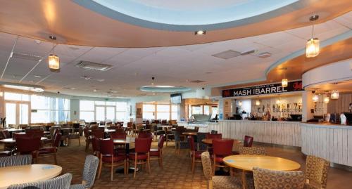 a restaurant with tables and chairs and a bar at Caravan to Hire - CalaGran Fleetwood Blackpool in Fleetwood