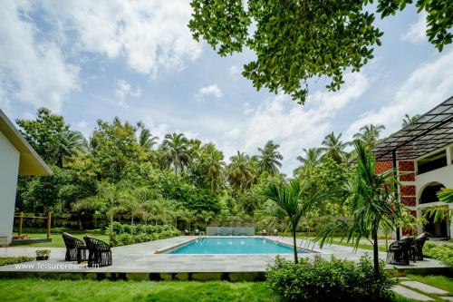 a swimming pool in the backyard of a house at Leisure Resort in Pondicherry