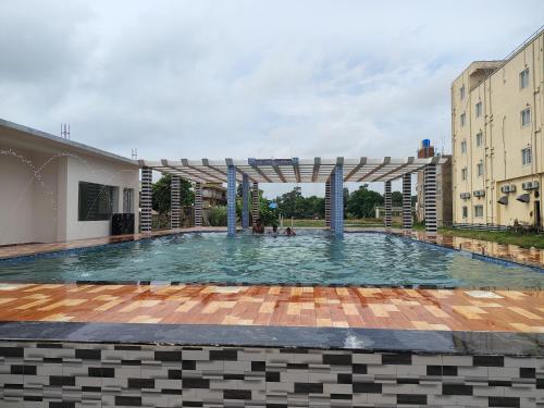 a large swimming pool in the middle of a building at Sea Smile Inn in Mandarmoni