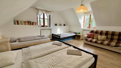 a living room with two beds and a couch at Chalupa v Hliníku in Hliník nad Hronom