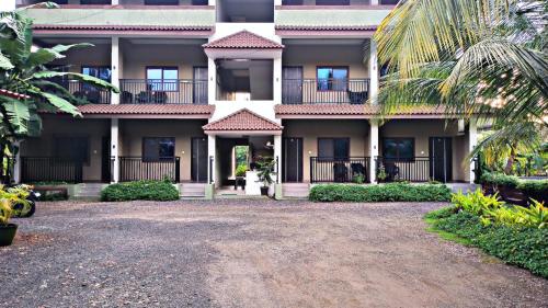 an apartment building with a driveway in front of it at Leela beachside stay in Kashid