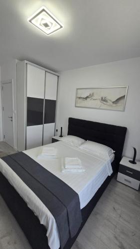 a bedroom with a large bed with white sheets at Marina Residence 2 in Constanţa
