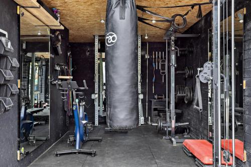 a gym with a punching bag in the middle at Sea Holly House - Where Architecture Meets the Ocean in Beer
