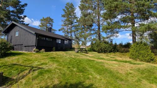 eine Scheune mit einem Picknicktisch vor einem Hof in der Unterkunft Soltoppen - cozy 3 bedroom cabin close to Norefjell 
