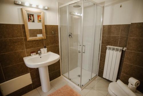 a bathroom with a shower and a sink at GuestHost - Mecenate Bright Apartment Milan in Milan