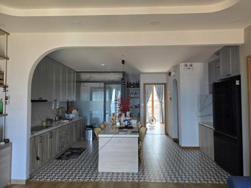 a kitchen with a table in the middle of it at Jana Hotel & Apartment - Firework & Aquatopia Water Park in Phu Quoc
