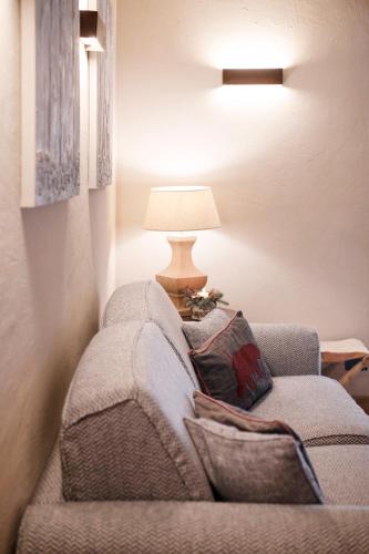 a living room with a chair with a lamp at Au Coeur Des Neiges Resort SPA & FREE E-BIKE in Courmayeur