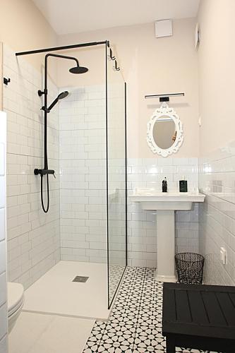a bathroom with a glass shower stall and a sink at D Rooms Boutique Stay with Parking & Fast City Access in Ljubljana