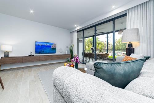 a living room with a couch and a table at Beachside 2 bedrooms apartment 200 meters to Bang Tao Beach Manage by OCEAN HUB in Bang Tao Beach