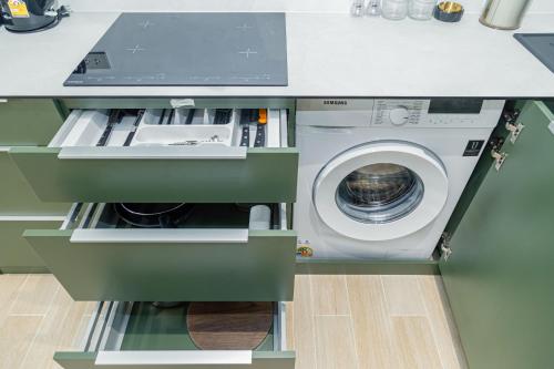 a laundry room with a washing machine in a kitchen at Beachside 2 bedrooms apartment 200 meters to Bang Tao Beach Manage by OCEAN HUB in Bang Tao Beach