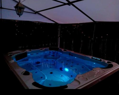 a jacuzzi tub on a balcony at night at VILLA STRAVANATA - Large Pool, Car and Large Whirlpool Jacuzzi in San Gregorio