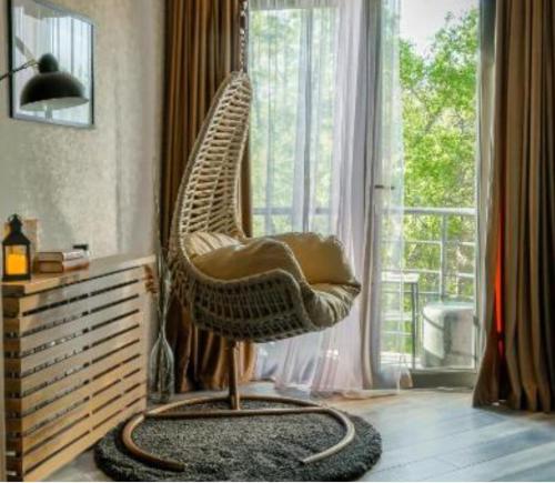 a hanging chair in a room with a window at Snowdrop home in Tsaghkadzor