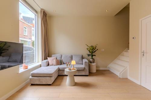 a living room with a couch and a window at City & Trainhouse in Alkmaar