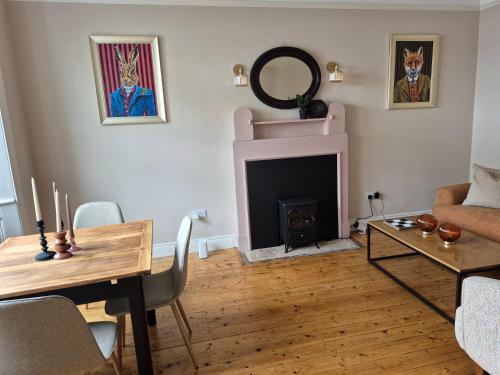 a living room with a table and a fireplace at Ensuite room Cloughjordan 3 in Cloghjordan
