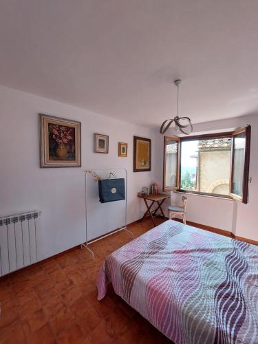 a bedroom with a bed and a window at Il Fienile in Casole dʼElsa