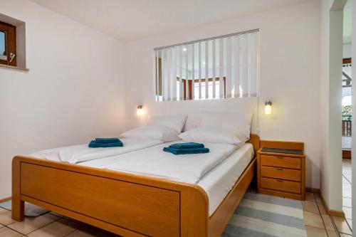 a bed with white sheets and blue towels on it at Gästehaus Heinemann - Eg3 in Langenargen