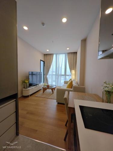 a living room with a couch and a tv at Brand New 2 bedroom near Paragon in Pratunam