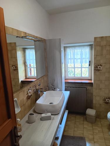 a bathroom with a white sink and a mirror at Il Sentiero in Verona