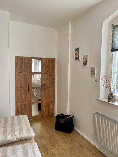 a room with a bed and a wooden door at Ferienwohnung - Auszeit - Buchholzer Straße 29 in Annaberg-Buchholz